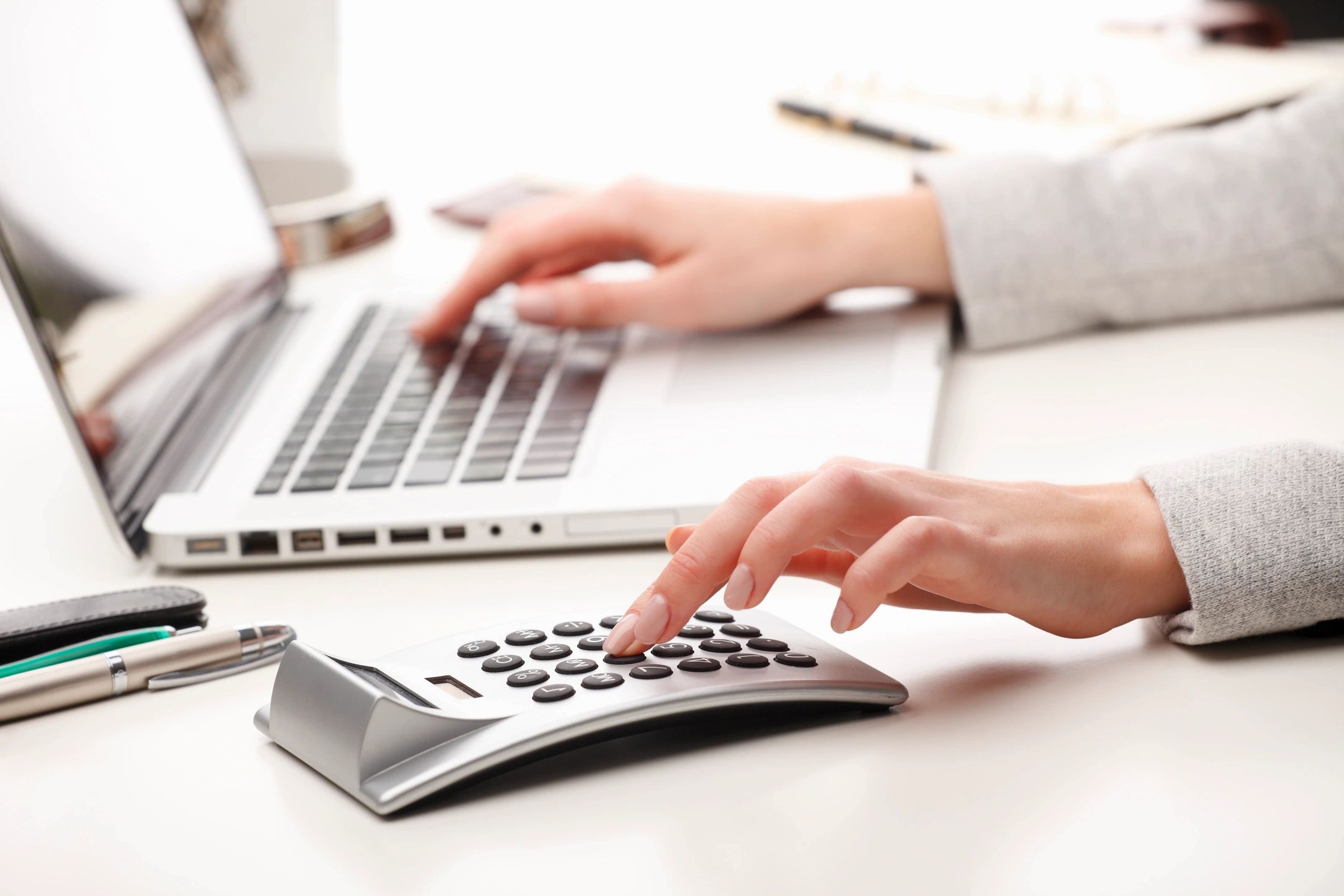 Professional workspace with laptop and calculator